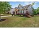 Landscaped front yard featuring healthy bushes and a green lawn, showcasing a welcoming curb appeal at 4929 Norman Park Pl, Clover, SC 29710