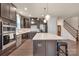 Well-equipped kitchen with stainless steel appliances, dark cabinetry, and a marble-topped island at 4929 Norman Park Pl, Clover, SC 29710