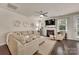 Bright living room with fireplace, large sectional sofa, area rug, and ceiling fan at 4929 Norman Park Pl, Clover, SC 29710