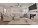 Comfortable living room with plush seating, fireplace, neutral tones, and a large ceiling fan at 4929 Norman Park Pl, Clover, SC 29710