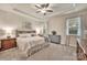 Comfortable bedroom featuring tray ceilings, neutral tones, and ample natural light at 4929 Norman Park Pl, Clover, SC 29710