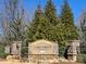 Stone entrance sign for Lake Crest community surrounded by lush trees and landscaping at 4929 Norman Park Pl, Clover, SC 29710