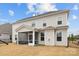 View of the back of the home, featuring a screened-in porch and well-manicured backyard with a black metal fence at 5024 Hillshire Ln, Mint Hill, NC 28227