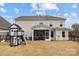 Home's backyard featuring a charming playset with a slide and swingset alongside the screened-in porch at 5024 Hillshire Ln, Mint Hill, NC 28227