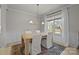 Well-lit dining area with a rustic wooden table, modern lighting, and large window at 5024 Hillshire Ln, Mint Hill, NC 28227