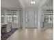 Bright and airy entryway with a white door, hardwood floors, and transom windows at 5024 Hillshire Ln, Mint Hill, NC 28227