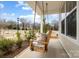 A cozy front porch with a swing, offering a relaxing outdoor space with views of the neighborhood at 5024 Hillshire Ln, Mint Hill, NC 28227