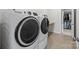Bright laundry room featuring a new GE washer and dryer and herringbone floors at 5024 Hillshire Ln, Mint Hill, NC 28227