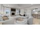 Comfortable living room featuring large windows, a stone fireplace, and modern furnishings at 5024 Hillshire Ln, Mint Hill, NC 28227