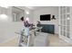 A home office featuring modern decor, a glass desk, and a TV mounted on the wall at 5024 Hillshire Ln, Mint Hill, NC 28227