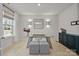 Bright office with a modern glass desk, accent lighting and hardwood floors at 5024 Hillshire Ln, Mint Hill, NC 28227
