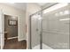 Bright bathroom showcasing tiled walk-in shower with glass door and modern fixtures at 515 Stickley Pl, Lancaster, SC 29720