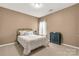 Inviting bedroom featuring a brass bed frame, carpet flooring, and a dark cabinet at 515 Stickley Pl, Lancaster, SC 29720