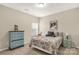 Charming bedroom showcasing a blue dresser, a comfortable bed, and a bright window at 515 Stickley Pl, Lancaster, SC 29720