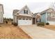 Exterior showcasing brick facade, a two-car garage, and well-maintained lawn at 515 Stickley Pl, Lancaster, SC 29720