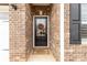 Close-up of the front door with decorative wreath and welcome mat at 515 Stickley Pl, Lancaster, SC 29720