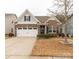 Charming brick home featuring a two-car garage and professionally landscaped front yard at 515 Stickley Pl, Lancaster, SC 29720