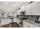 Modern kitchen featuring white cabinets, granite counters, and stainless steel appliances at 515 Stickley Pl, Lancaster, SC 29720