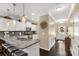 Open kitchen with a granite island, white cabinets and stainless steel appliances at 515 Stickley Pl, Lancaster, SC 29720