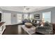 Bright and airy living room featuring hardwood floors, stylish furniture, and large windows with plantation shutters at 515 Stickley Pl, Lancaster, SC 29720