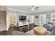 Comfortable living space with hardwood floors, a ceiling fan, an entertainment center, and access to the laundry room at 515 Stickley Pl, Lancaster, SC 29720