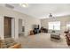 Bright living room with neutral walls, carpet, ceiling fan, and lots of natural light from large windows at 515 Stickley Pl, Lancaster, SC 29720