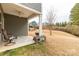Covered patio with seating overlooking the landscaped backyard and lush greenery at 515 Stickley Pl, Lancaster, SC 29720