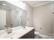 Double vanity bathroom with a large mirror and subway tile at 5422 Army Rd, Marshville, NC 28103