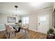Bright dining room with a glass table and hardwood floors at 5422 Army Rd, Marshville, NC 28103