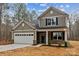 Two-story house with gray siding, white garage door, and a brick facade at 5422 Army Rd, Marshville, NC 28103