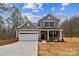 Two-story house with gray siding, white garage door, and a brick facade at 5422 Army Rd, Marshville, NC 28103