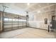 Unfinished garage with overhead door and water heater at 5422 Army Rd, Marshville, NC 28103
