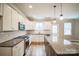 Modern kitchen with white cabinets, granite countertops, and a large island at 5422 Army Rd, Marshville, NC 28103