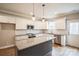Modern kitchen with white cabinets, granite countertops, and a large island at 5422 Army Rd, Marshville, NC 28103