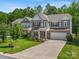 Two-story home with gray siding, two-car garage, and landscaped yard at 6029 Landry Ln, Indian Land, SC 29707