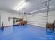 Spacious garage with painted floor, shelving, and room for two cars at 6029 Landry Ln, Indian Land, SC 29707