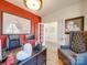 Spacious home office with red accent wall, hardwood floors, and built-in shelving at 6029 Landry Ln, Indian Land, SC 29707