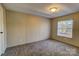 Bright bedroom with carpeted floor and large window at 6415 Sherwood Ln, Denver, NC 28037