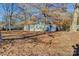 Mobile home exterior with tree-lined yard and shed at 6415 Sherwood Ln, Denver, NC 28037