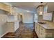 Open concept kitchen with white cabinets and wood-look floors at 6415 Sherwood Ln, Denver, NC 28037