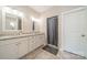Well-lit bathroom featuring double sinks with granite countertop and a tiled shower stall at 6835 Ingleside Dr, Sherrills Ford, NC 28673