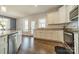Bright kitchen features white cabinets, stainless steel appliances, granite countertops and hardwood floors at 6835 Ingleside Dr, Sherrills Ford, NC 28673