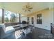 A covered back porch area includes a table, chairs, and outdoor couch perfect for relaxing outside at 6835 Ingleside Dr, Sherrills Ford, NC 28673