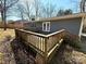 Angled rear view of the property with a wooden back deck accessible through double doors at 7124 Linda Lake Dr, Charlotte, NC 28215