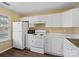 Functional kitchen featuring white appliances, ample counter space, and bright, neutral colors at 7752 Petrea Ln, Charlotte, NC 28227