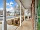 A covered porch with white pillars and lush landscaping featuring shrubs and a sidewalk at 7752 Petrea Ln, Charlotte, NC 28227