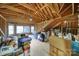 Unfinished attic space offering potential for customization, with exposed wood framing and natural light at 8011 S Dorchester Trce, Indian Land, SC 29707