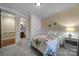 Bedroom with carpet flooring, neutral paint, walk-in closet and access to ensuite bathroom at 8011 S Dorchester Trce, Indian Land, SC 29707