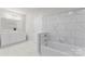 Bathroom with double vanity, bathtub, and marble tile at 806 S Martin Luther King Ave, Salisbury, NC 28144