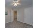 Neutral bedroom with carpet, view of hallway entrance and an interior door at 8065 Stoneham Ct, Matthews, NC 28105